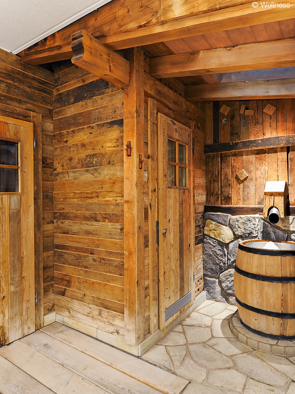 Ice fountain in the sauna at the Hotel Ermitage Ice in a wooden barrel and rustic surroundings