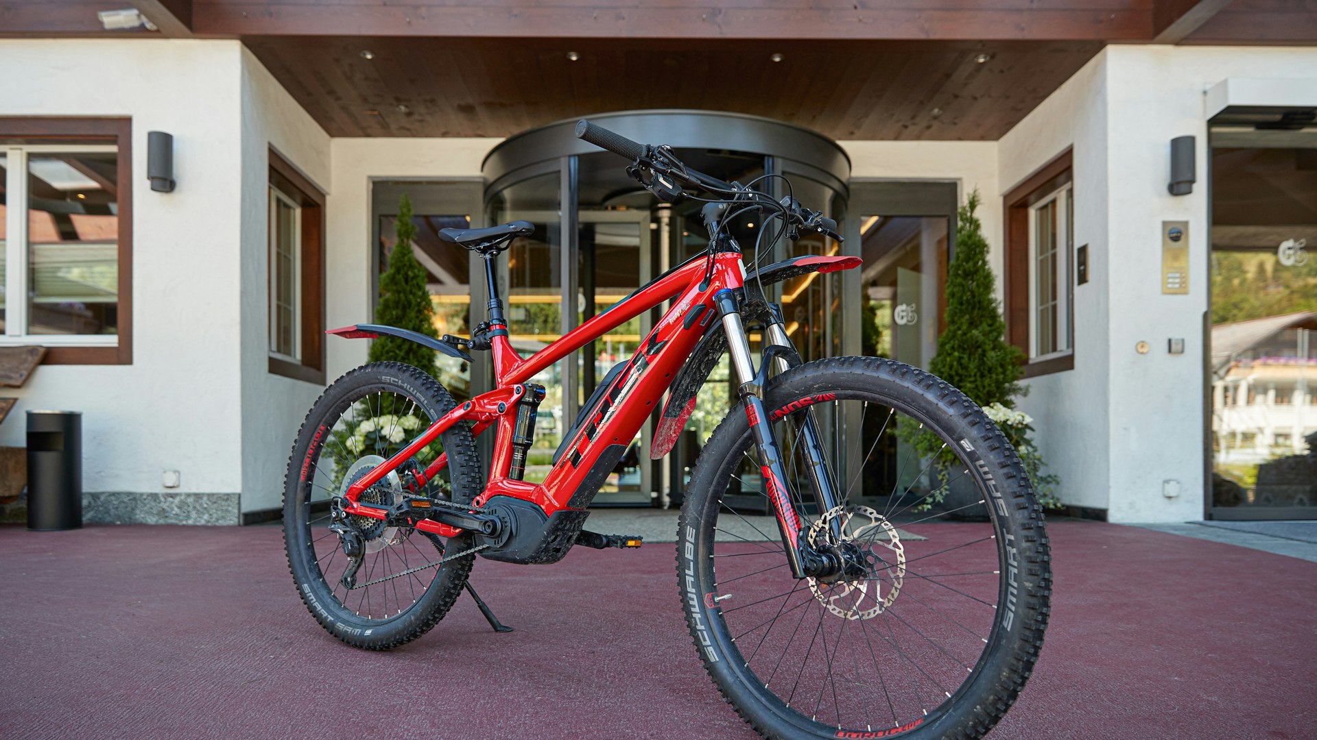 Ermitage bike Red mountain bike in front of hotel entrance
