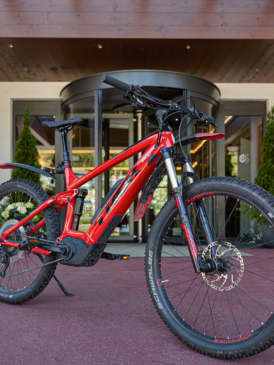 Ermitage bike Red mountain bike in front of hotel entrance