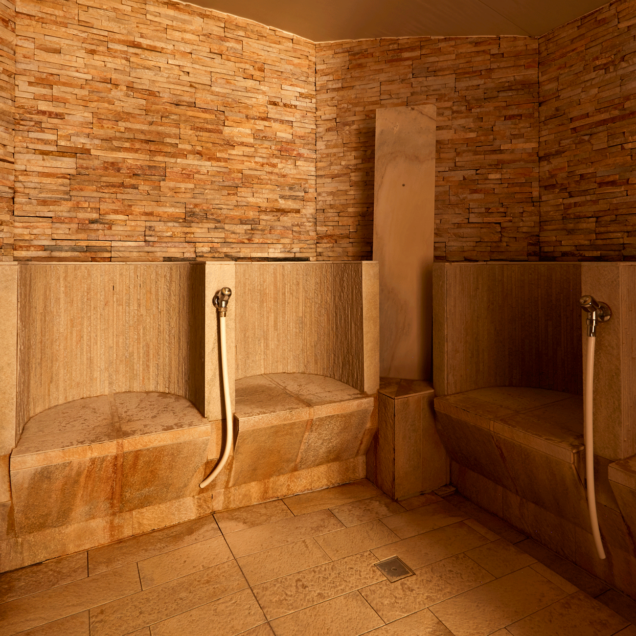 Steam bath at the Hotel Ermitage Steam bath made of wood and stone with separate seats