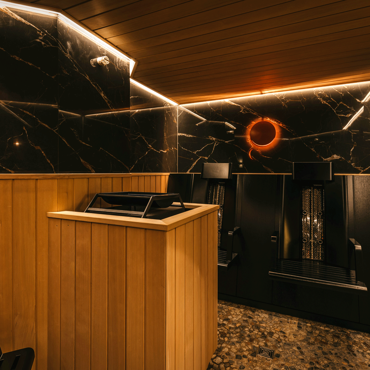 Infrared sauna at the Hotel Ermitage Dark sauna with wood and marble and infrared lamps