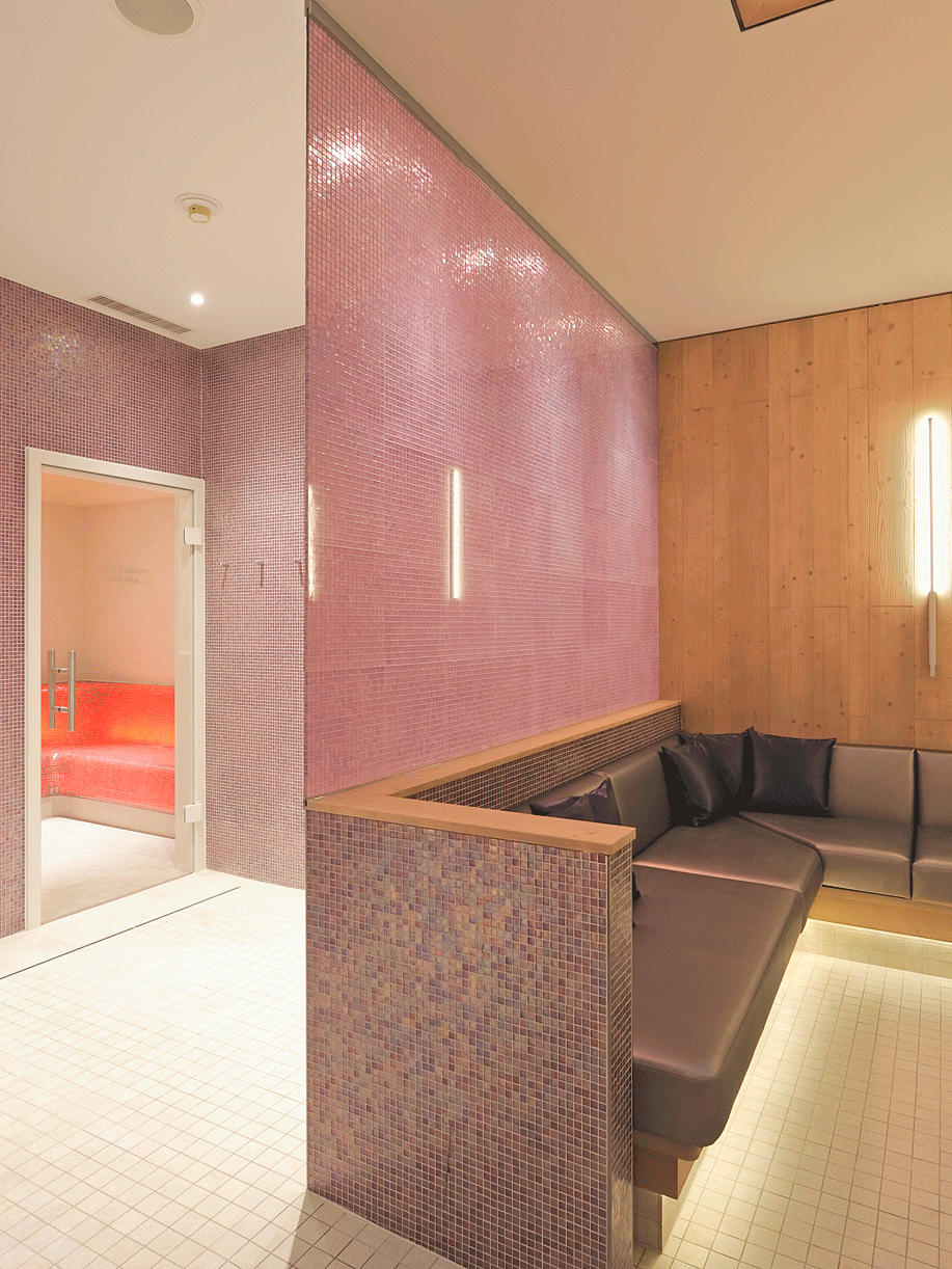 Ladies' Spa at the Hotel Ermitage Spa area with pink mosaic tiles, two doors to the steam bath and sauna on the left, sofas on the right