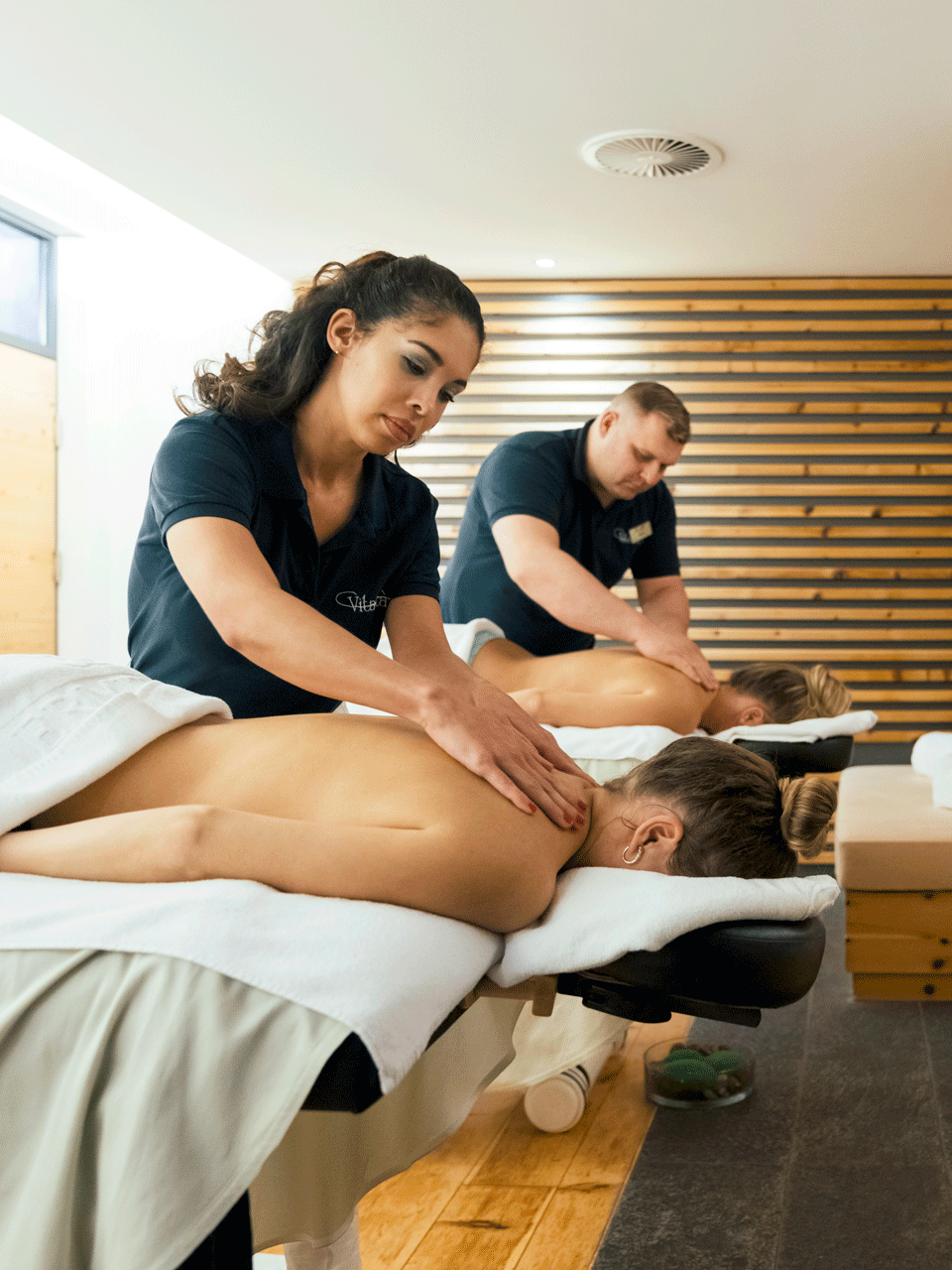Massage at the Hotel Ermitage Two women are massaged on the shoulders by a woman and a man