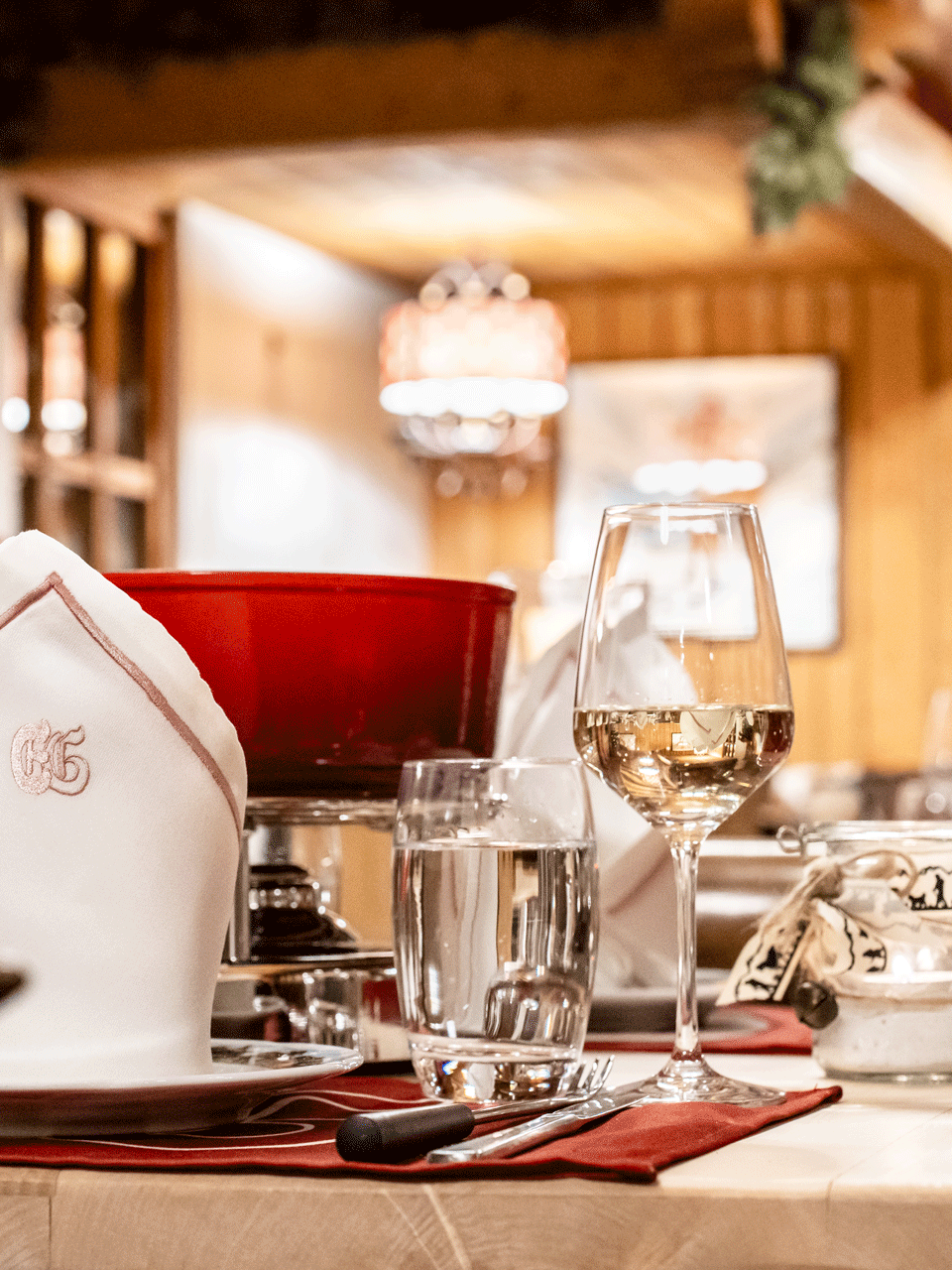 Fondue Spycher at the Hotel Ermitage Set table with fondue caquelon and wine