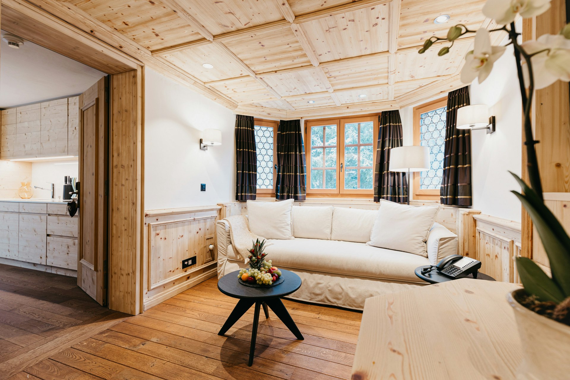 Wood-panelled room with glazed bay window and sofa