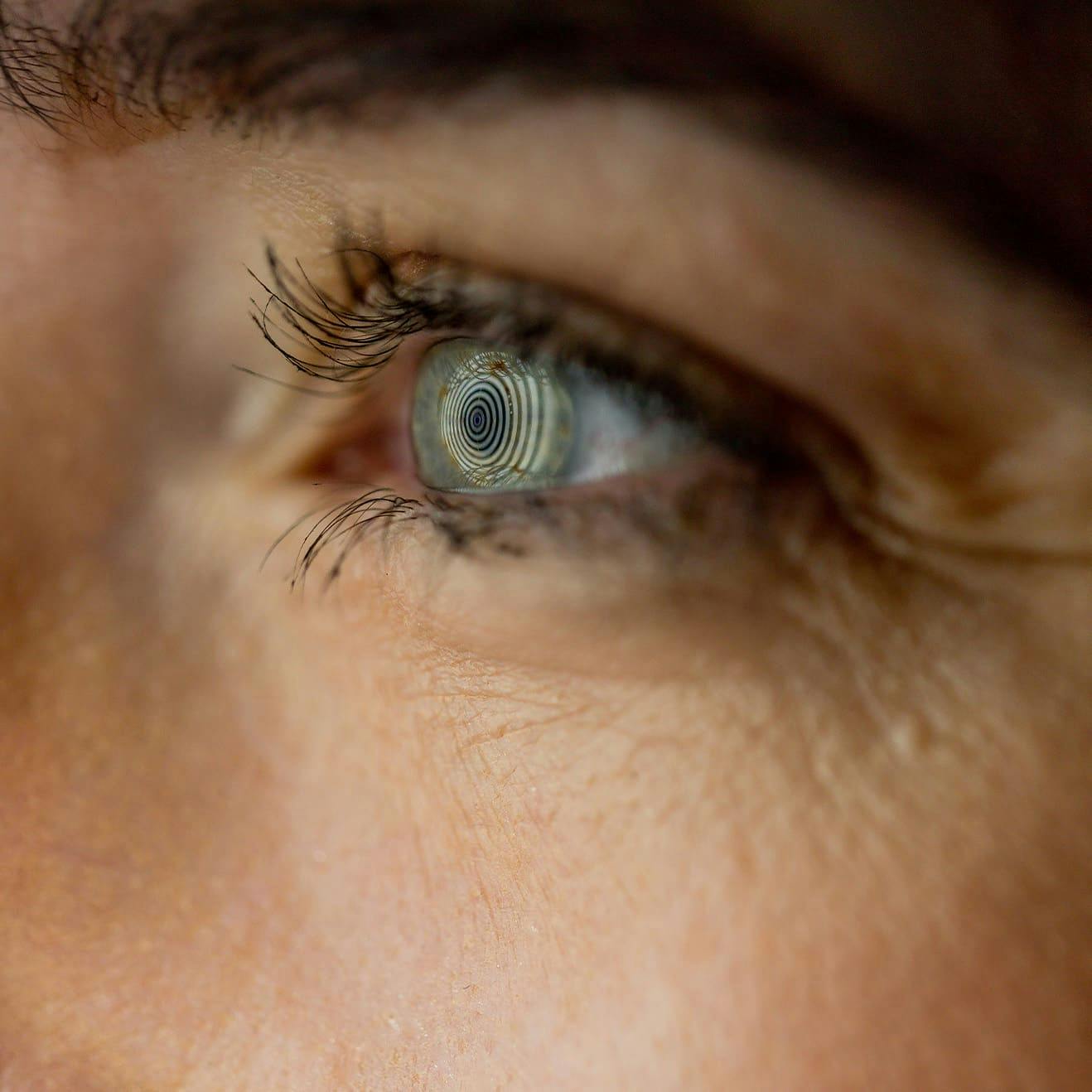 close up on eye looking at spiral design