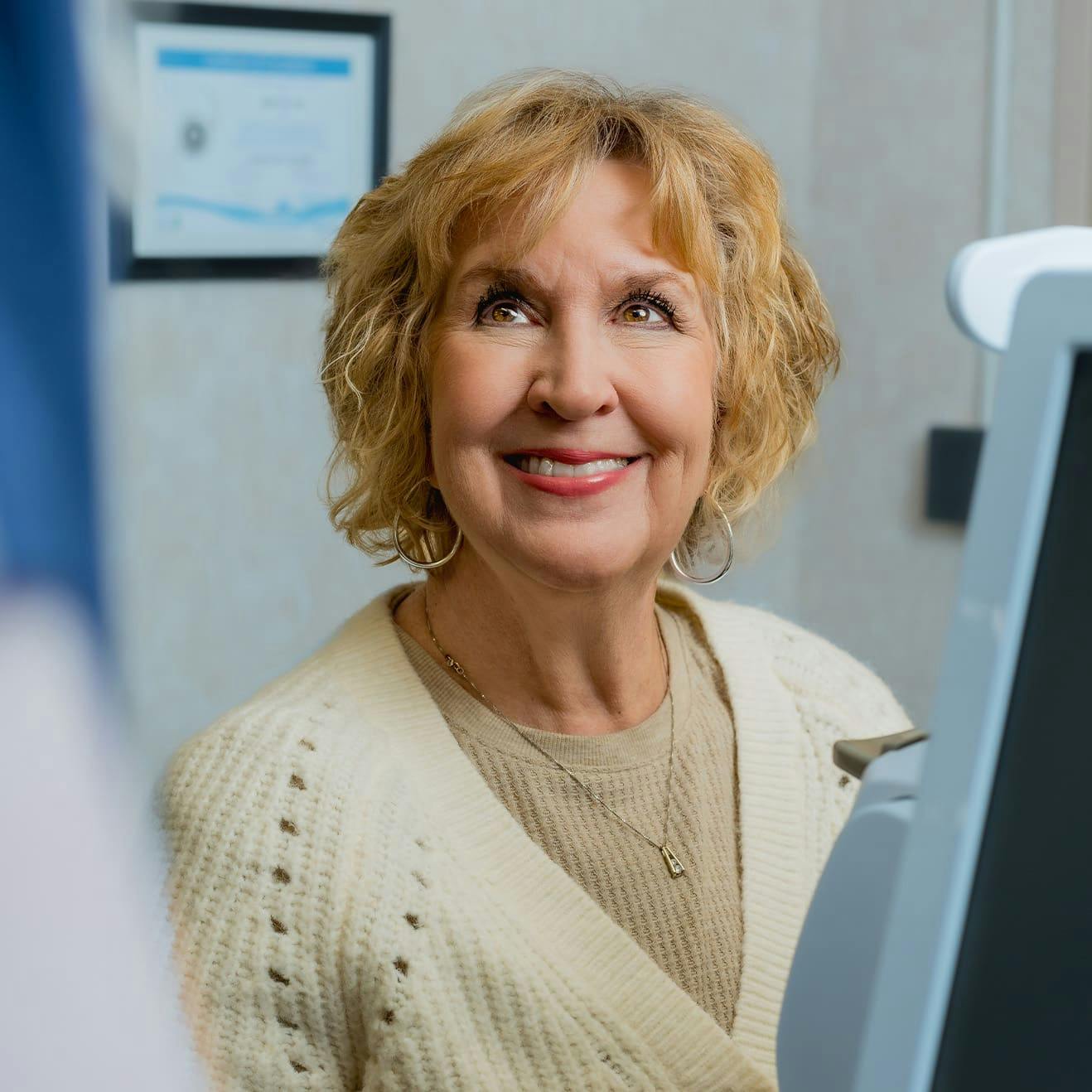 female patient smiling in eye doctor office