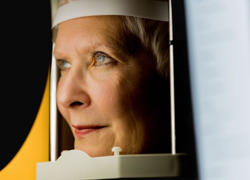 woman leaning in eye machine