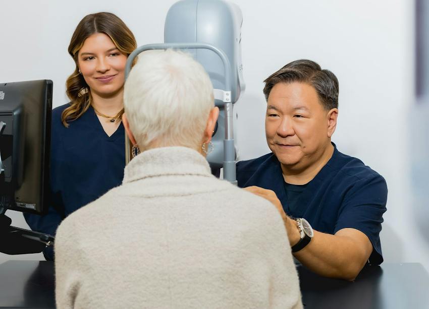 Dr. Chu helping patient getting their eyes checked