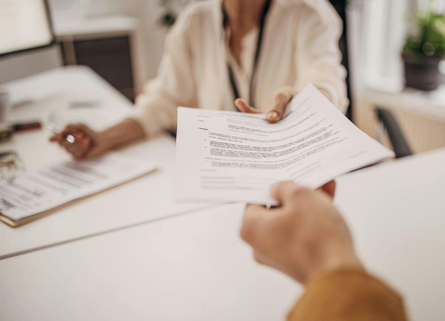 paper getting handed to a person