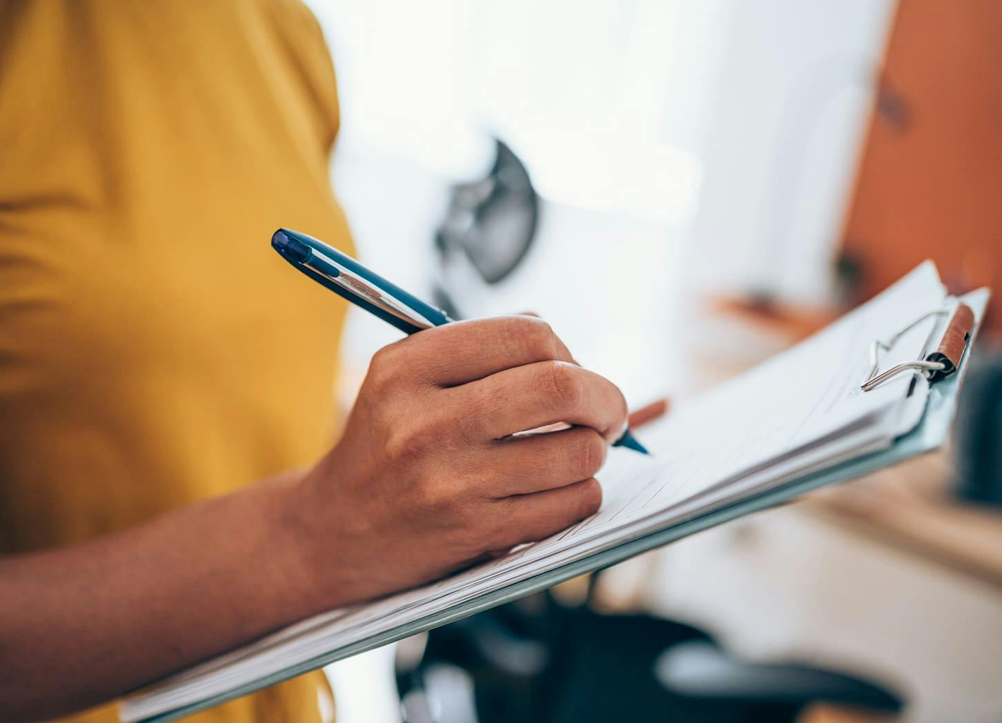close up on woman filling out paperwork
