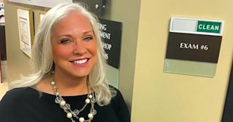 woman with blonde hair wearing a chunky necklace