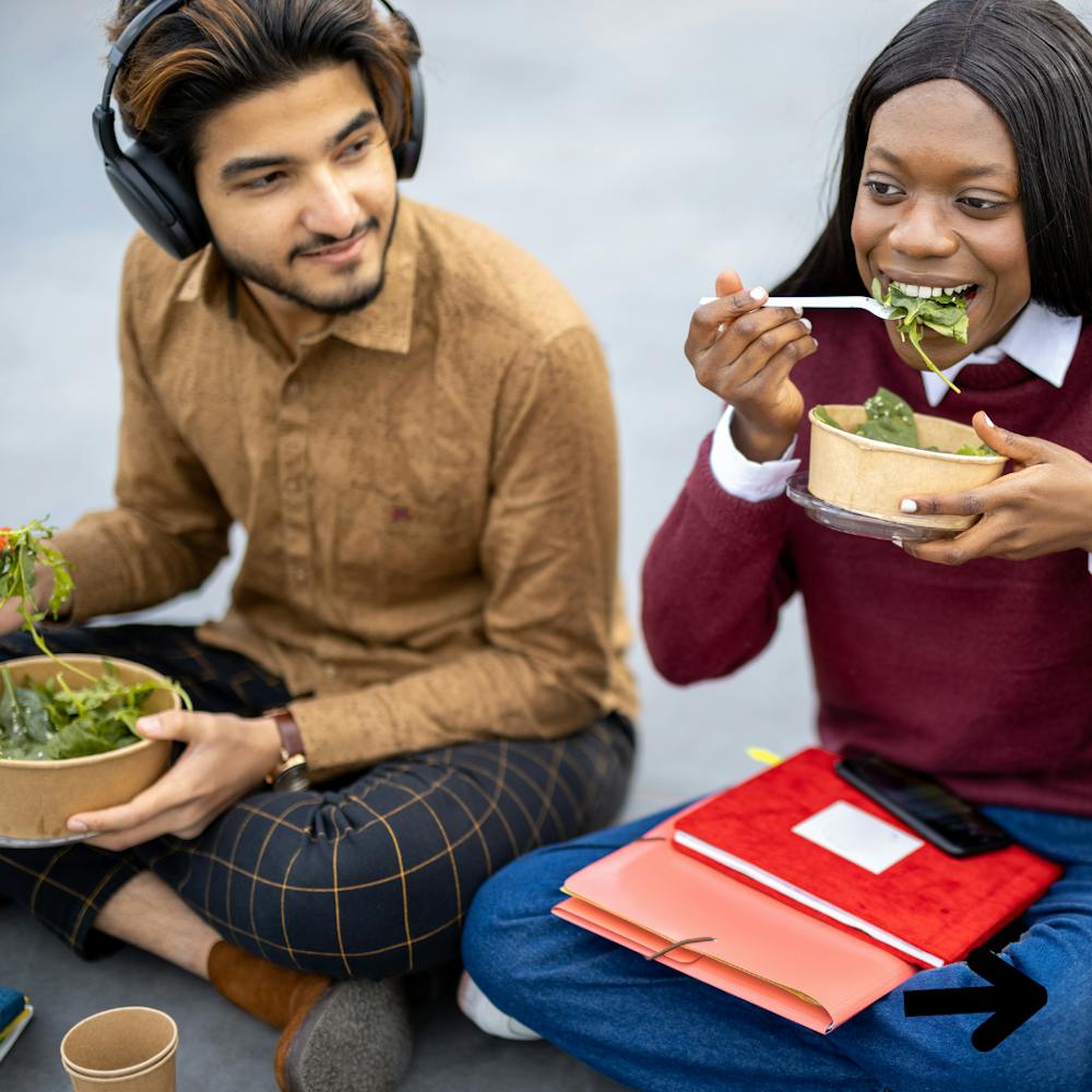 two friends eating salads
