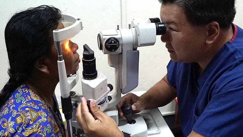 Dr. Chu looking at patient's eyes