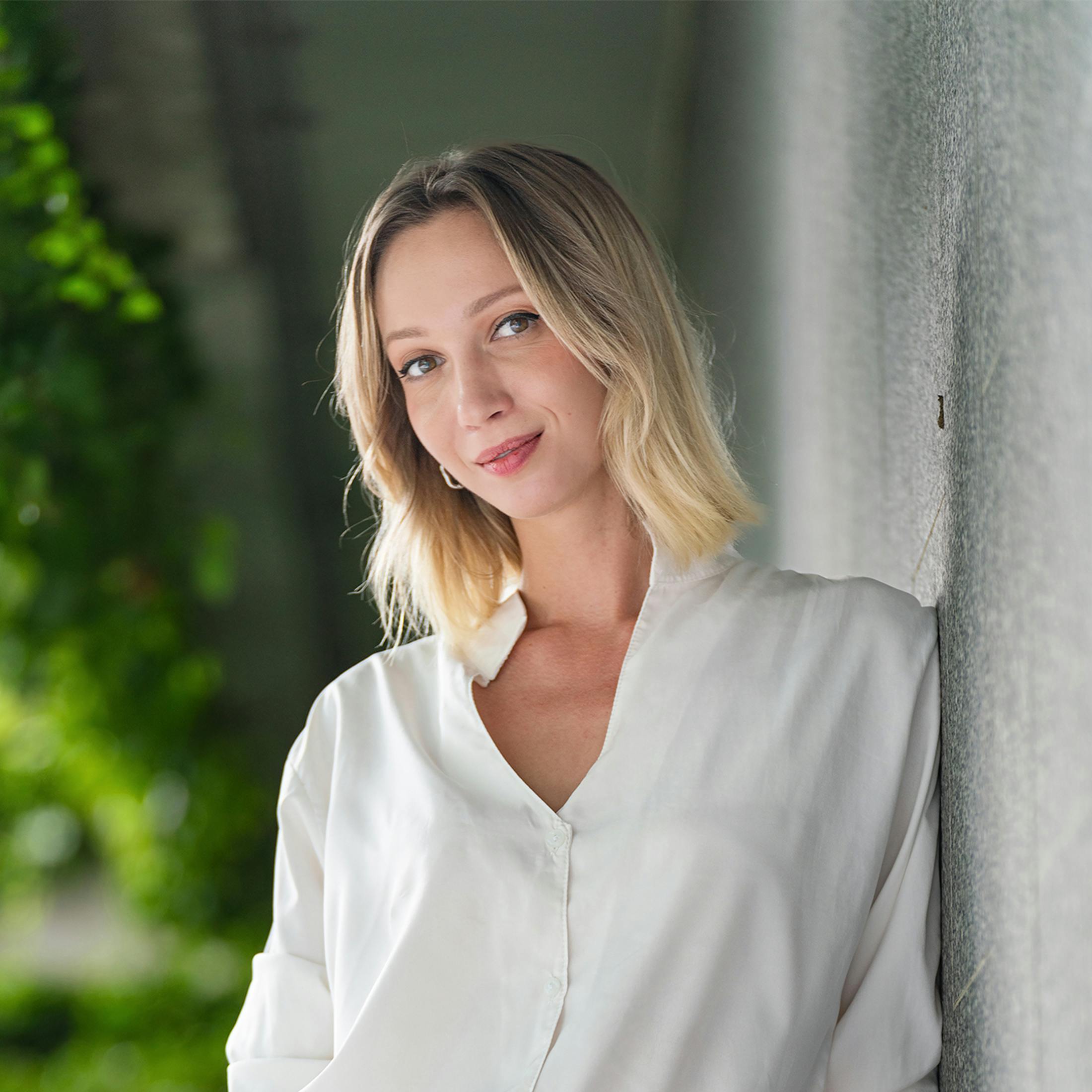 woman with blonde hair wearing a white shirt