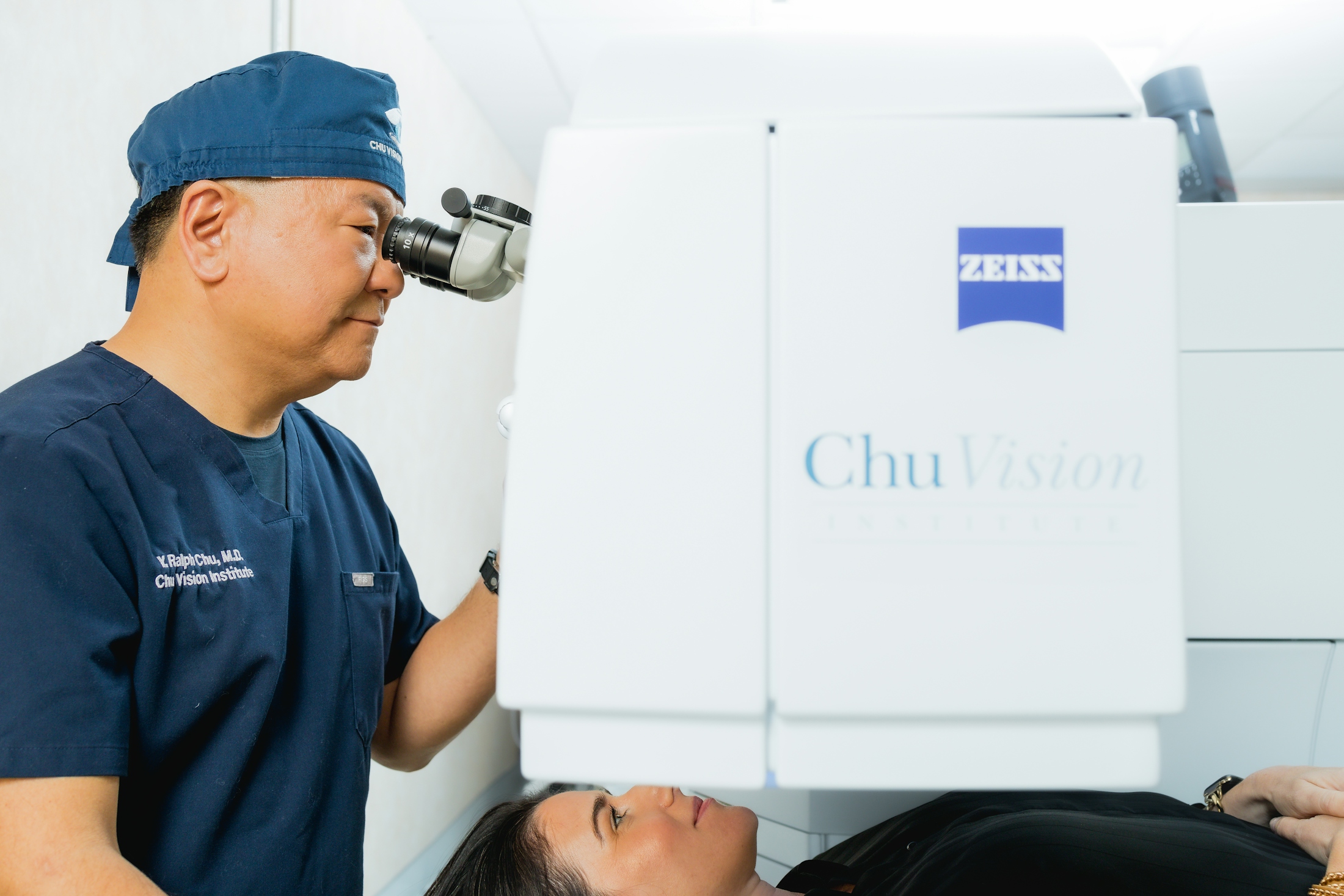 Dr. Chu using Zeiss to examen patient