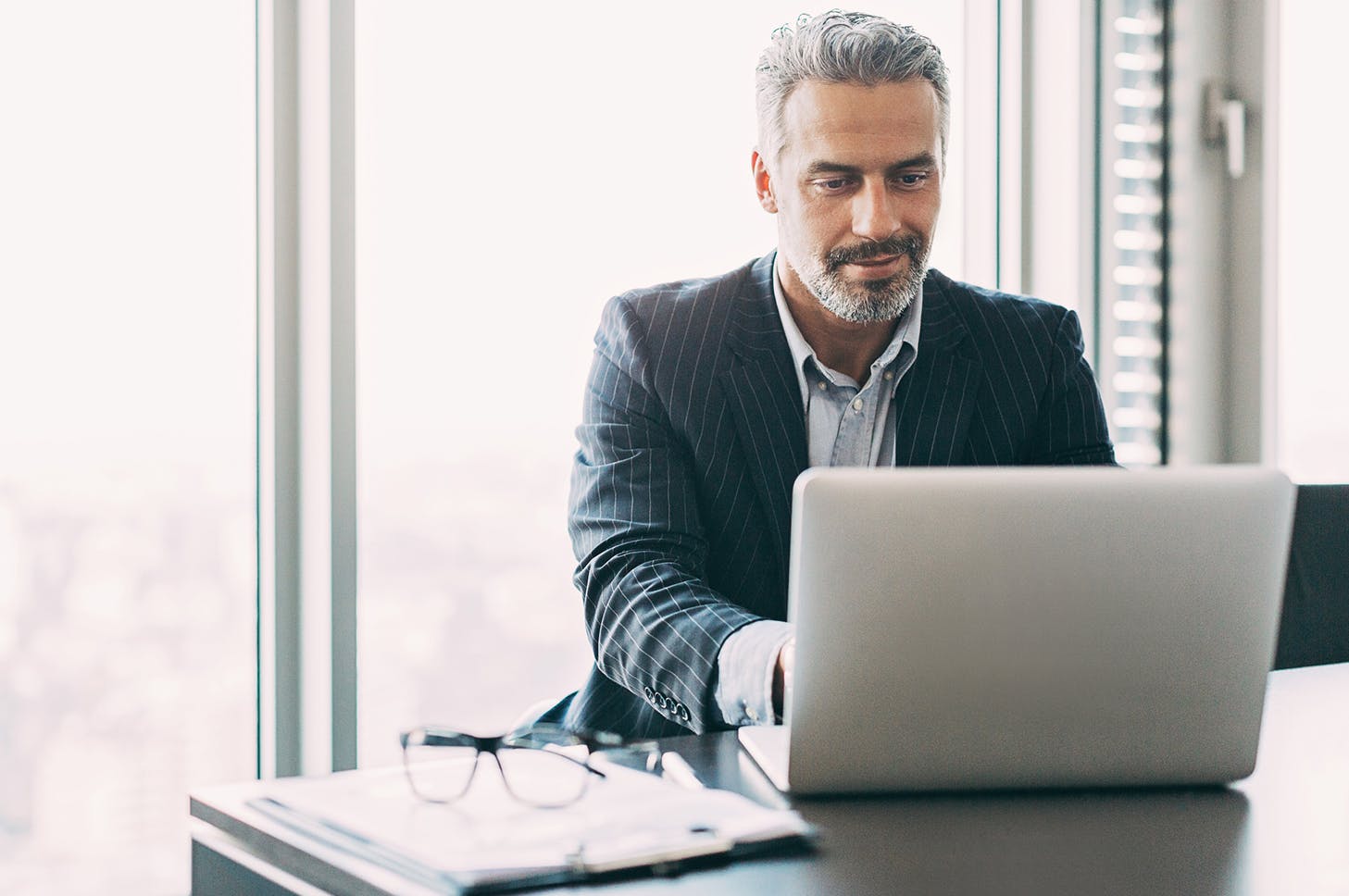a man sitting at a table with a laptop