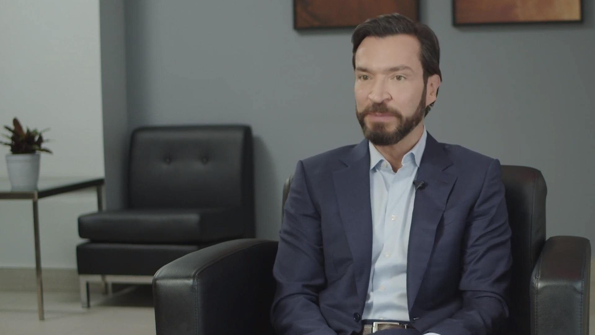 Dr. James Kelly with Kelly Vision sitting in a chair