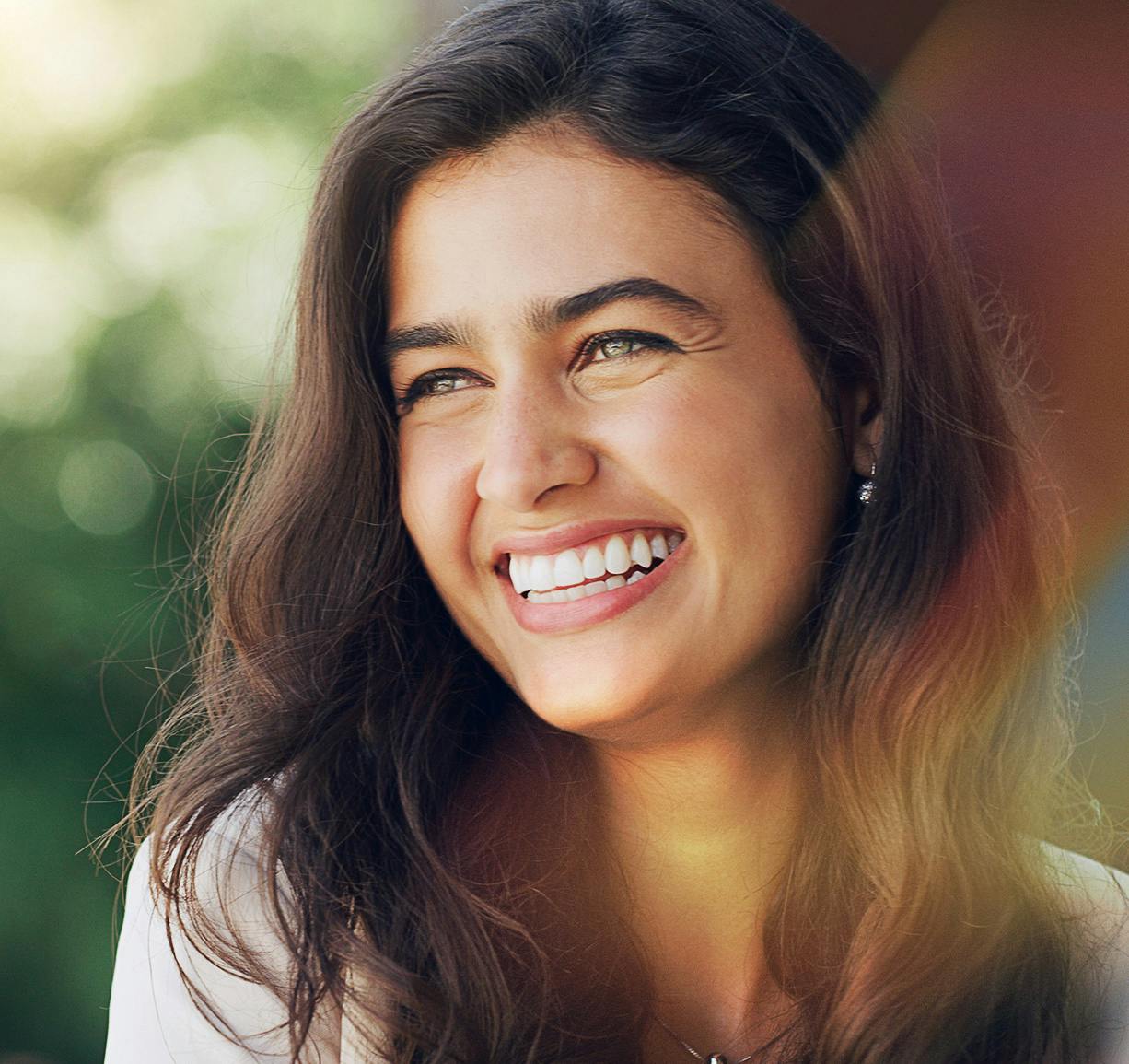 lady looking off to the side with big smile