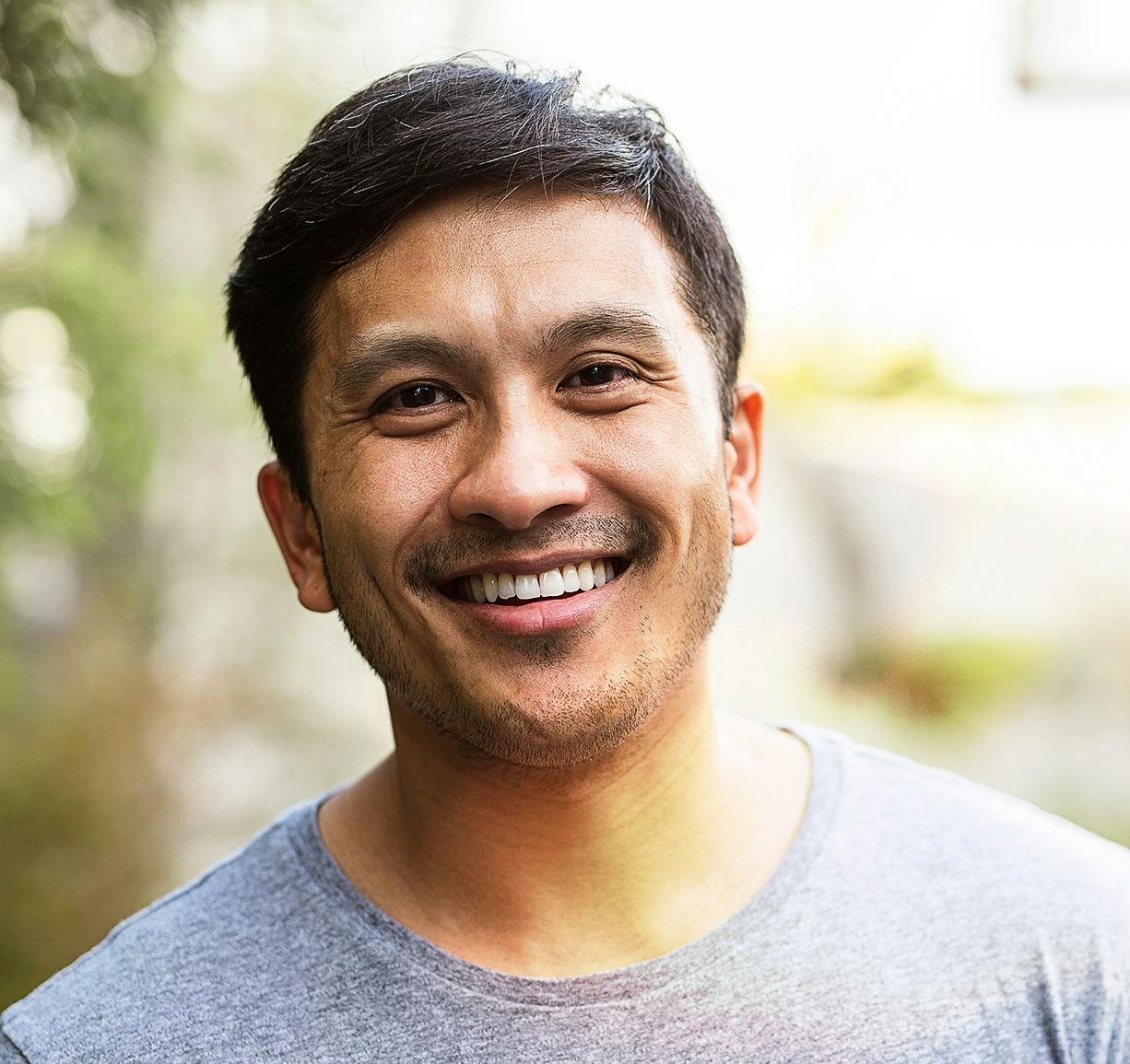 man looking straight and smiling