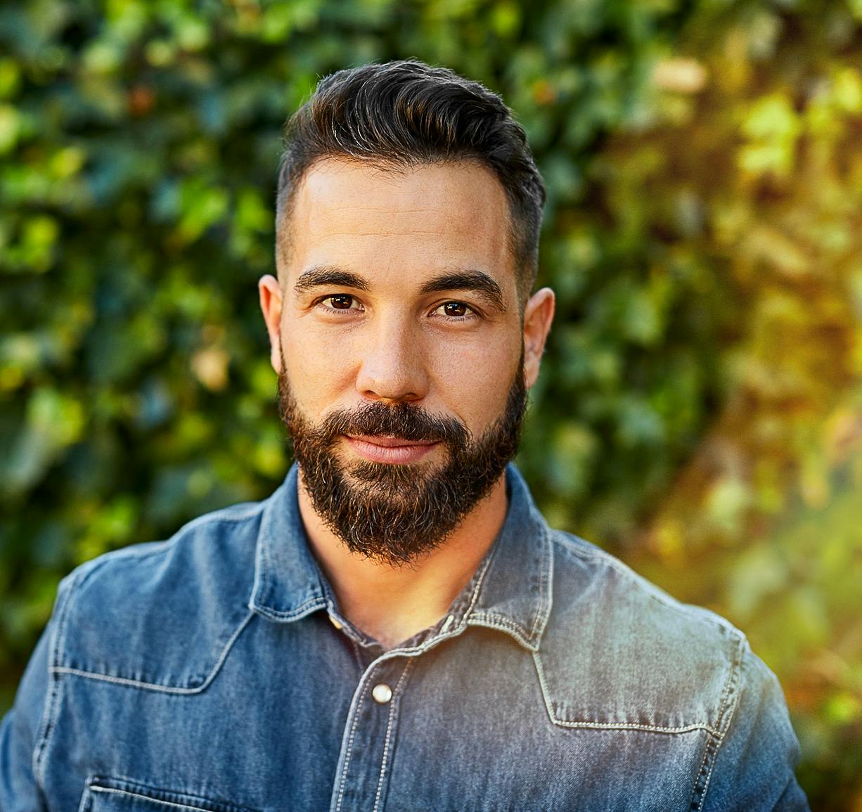 man looking straight and smiling