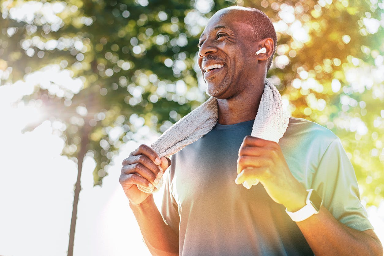 Man smiling with towel around neck