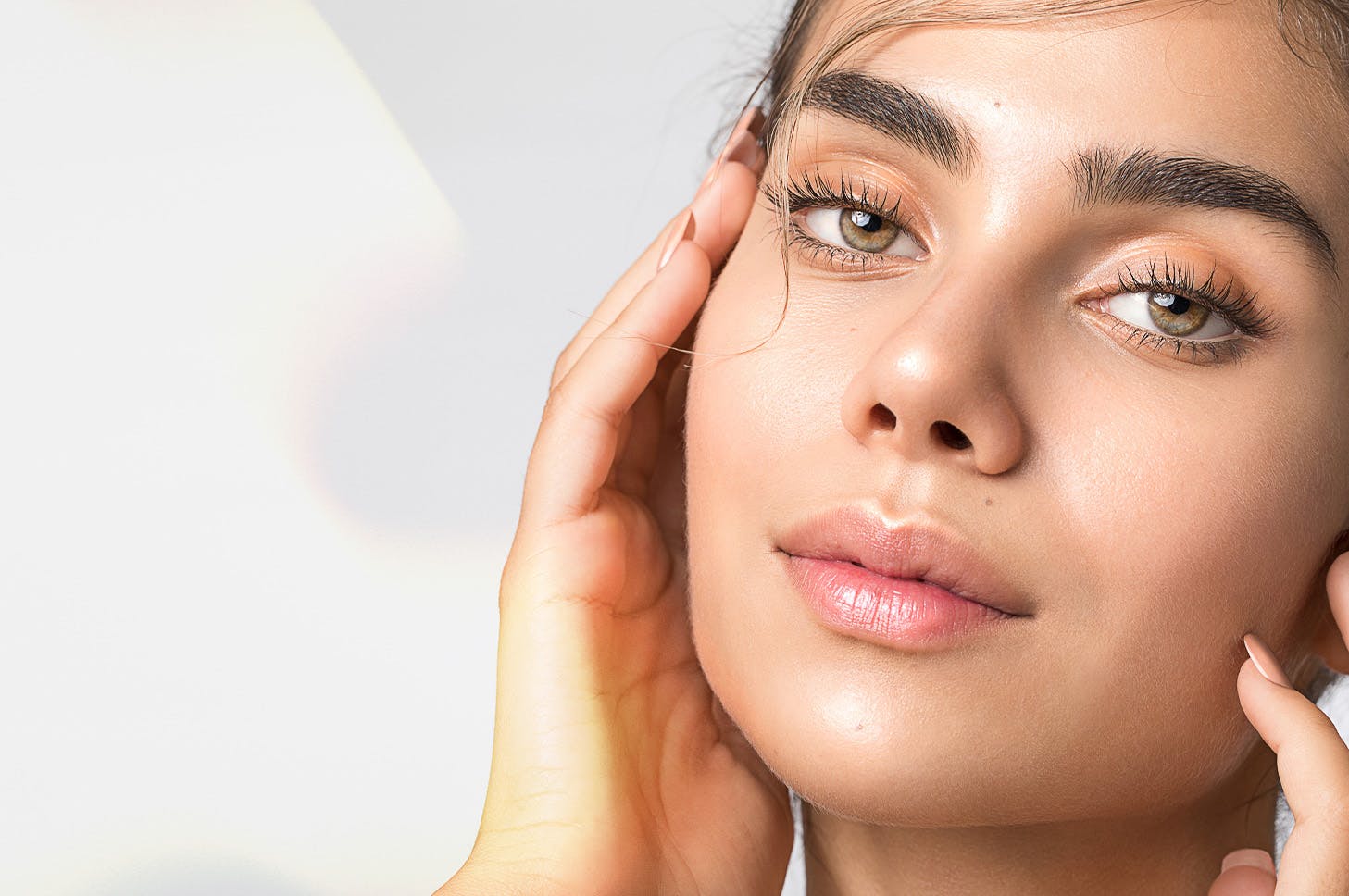 lady with hands on her face looking into the camera