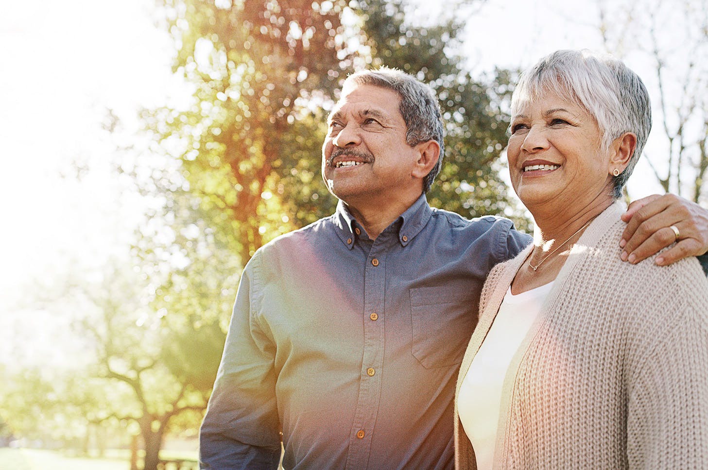 older man and woman looking out and smiling