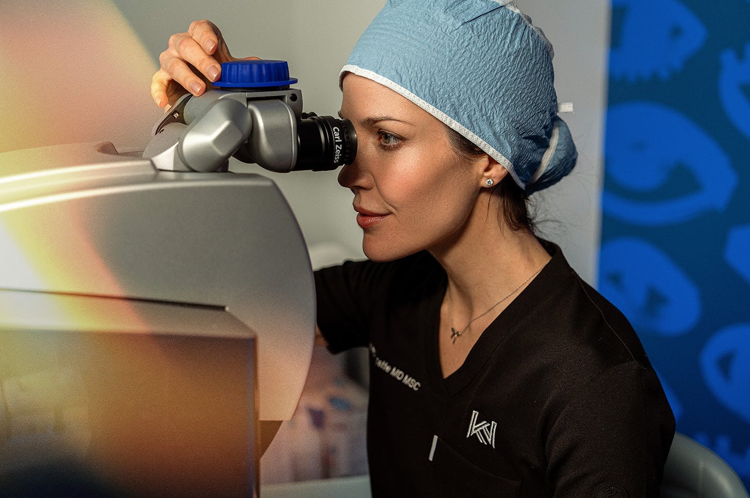 Female doctor looking into an eye exam scope