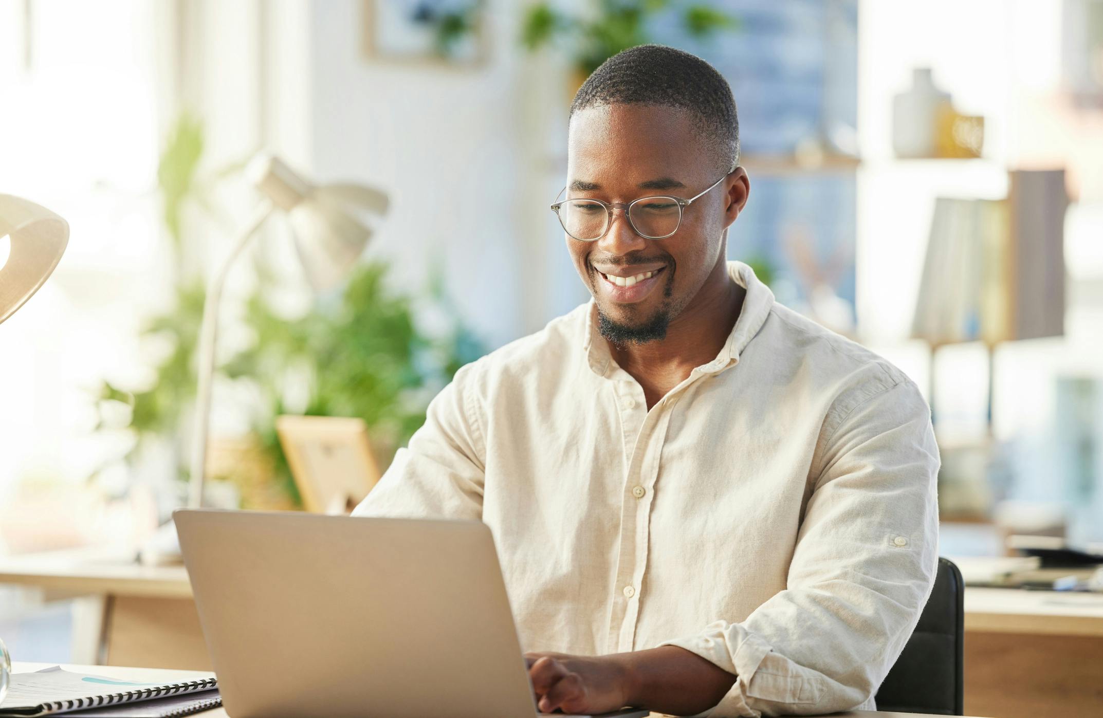 man smiling looking at computer