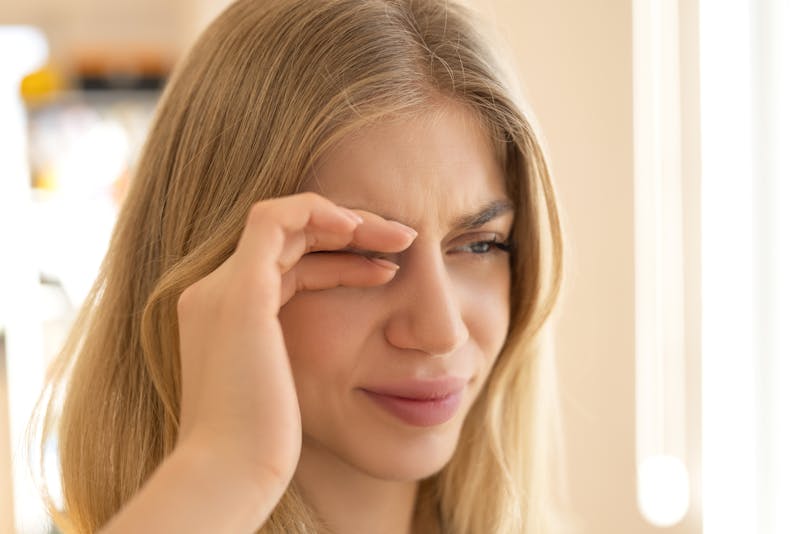 Woman rubbing her eye