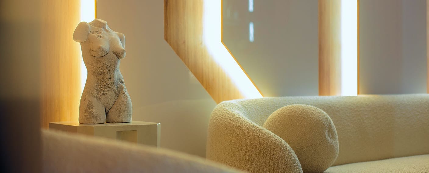 couch and statue of a woman's body
