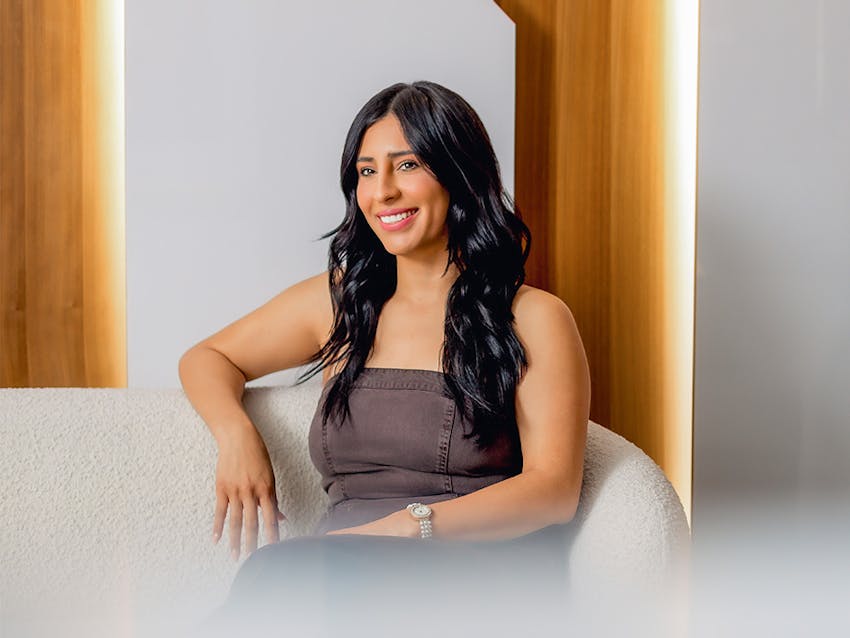 woman sitting on couch smiling