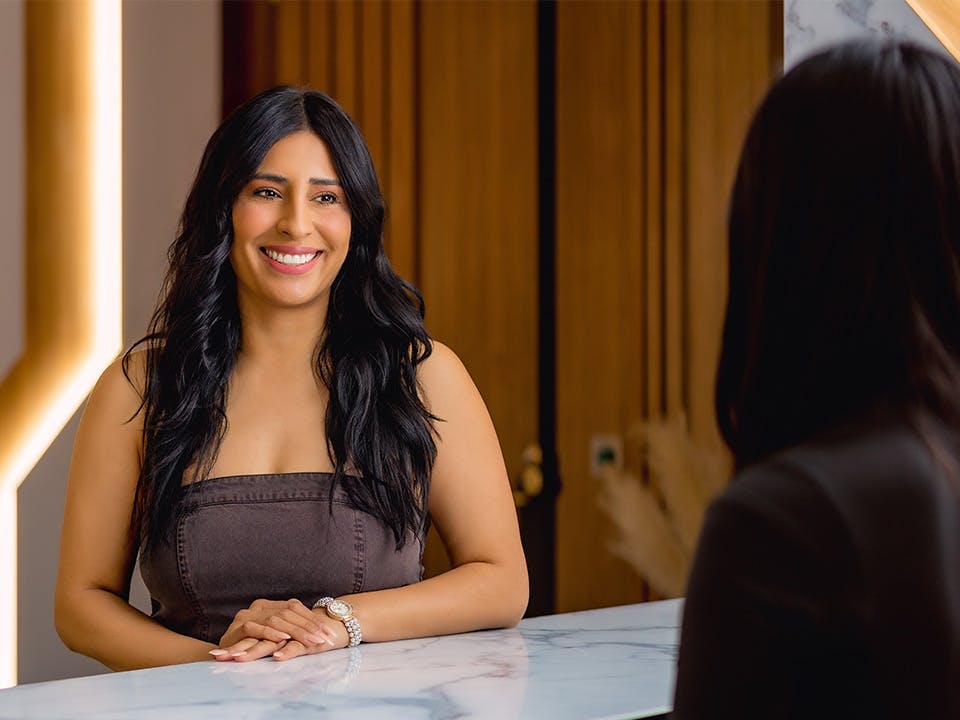 patient smiling at front desk