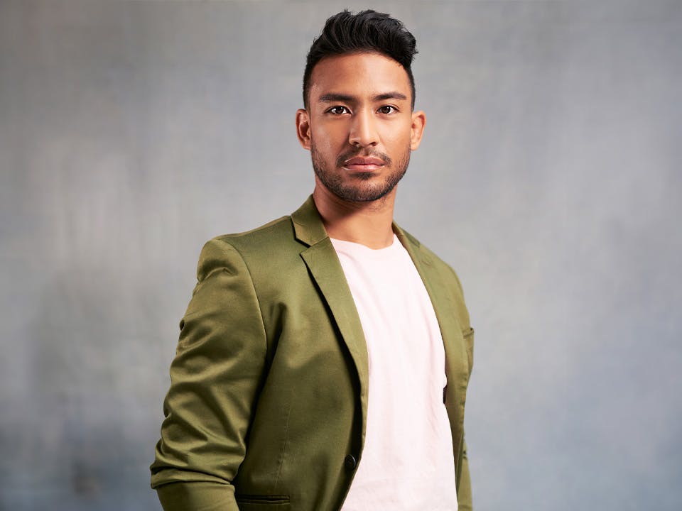 dark haired man in green jacket