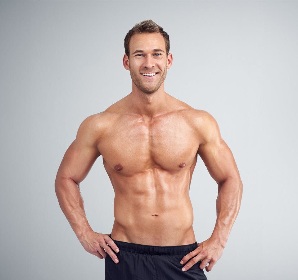 fit man with no shirt smiling