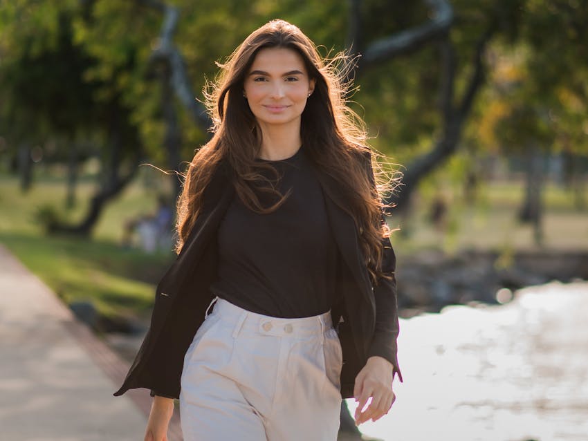 dark haired woman smiling and walking