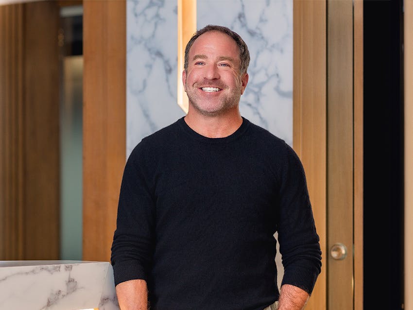 male patient in dark shirt smiling
