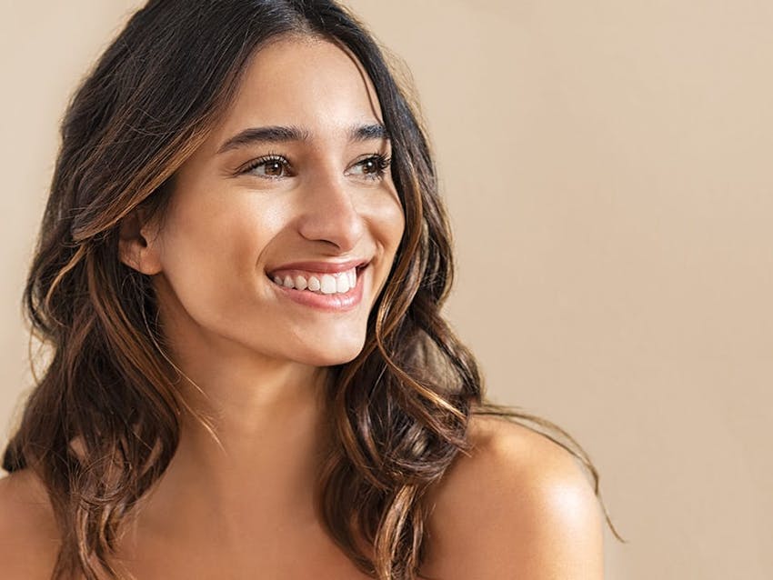 dark haired woman smiling looking off to the distance