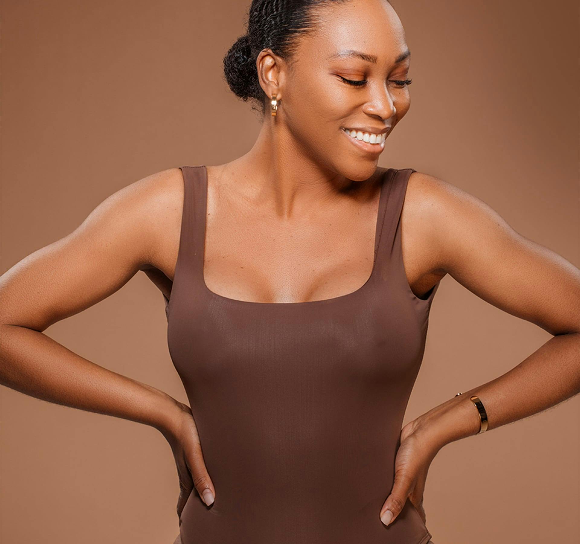 woman smiling with hands on hips