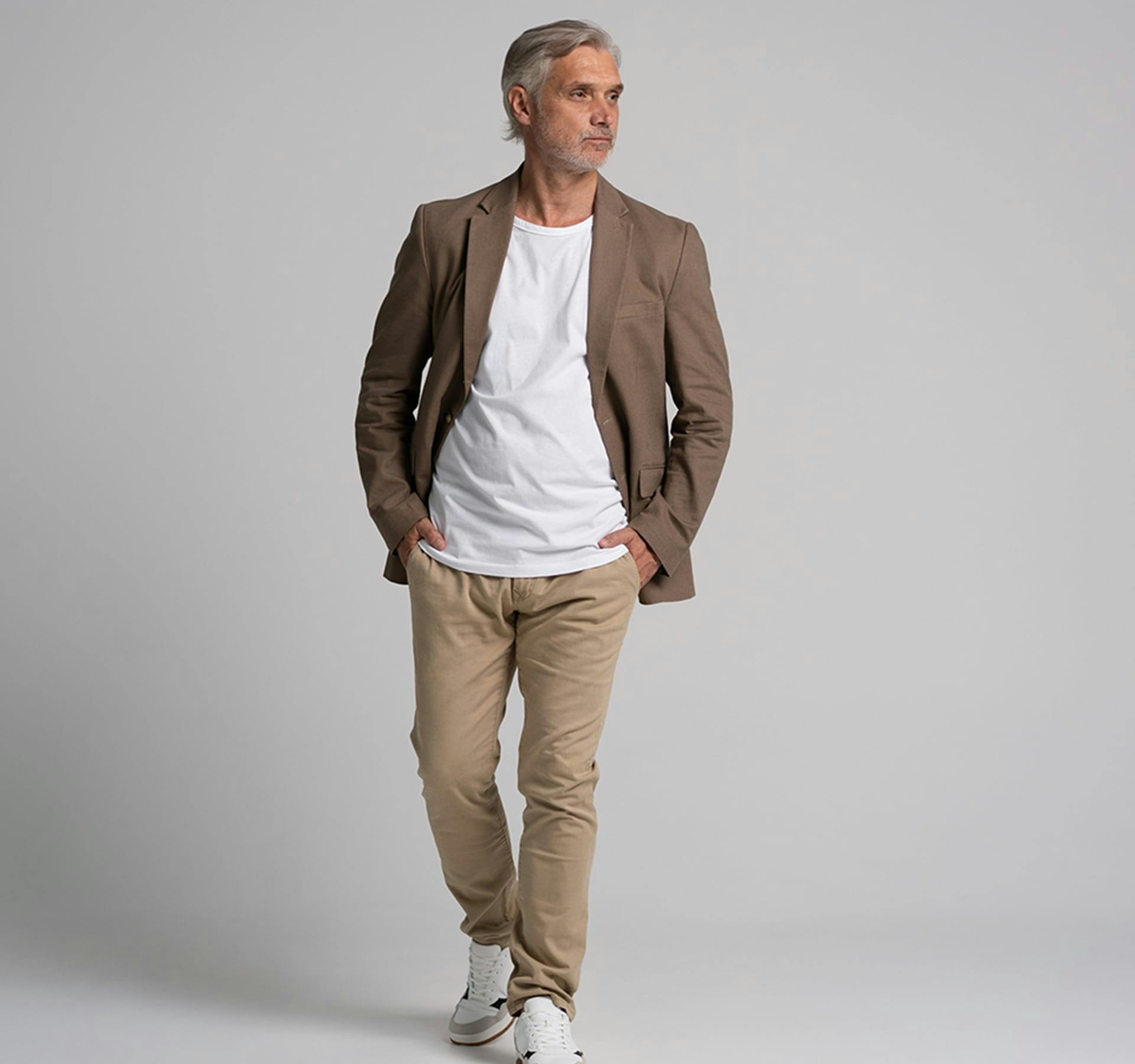 older male with hands in his pockets