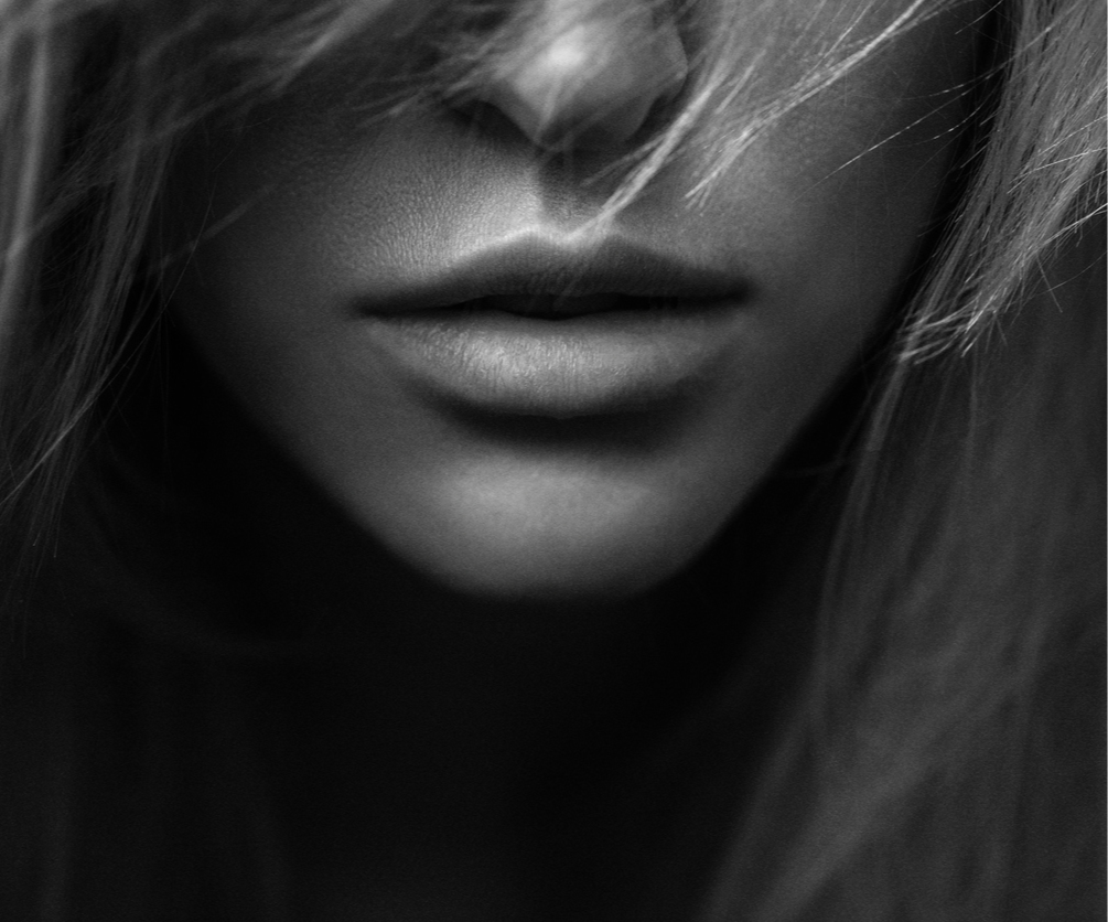 image of lower half of a woman's face. Her lips and chin are beautiful and have facial symmetry to show the potential results of a chin augmentation in Los Angeles