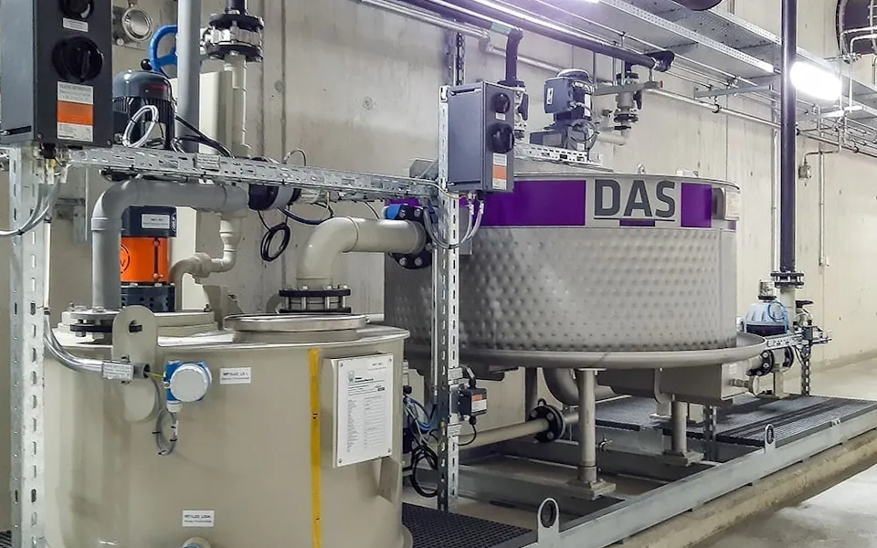 ARA Rhein E-PLATE The image shows an industrial setup with multiple tanks and pipes in a concrete room that is part of a DAS EE E-PLATE system.