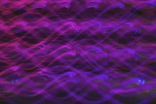 Membrane Technology Abstract light painting with vibrant purple and pink swirling patterns creates a dynamic and mesmerizing visual effect.