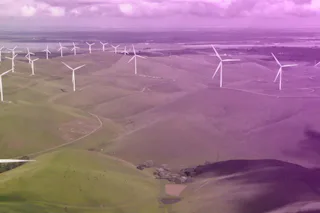 Zero-emission sub-fab A vast field of green rolling hills is dotted with numerous white wind turbines under a sky with scattered clouds, showcasing sustainable energy and renewable power resources.
