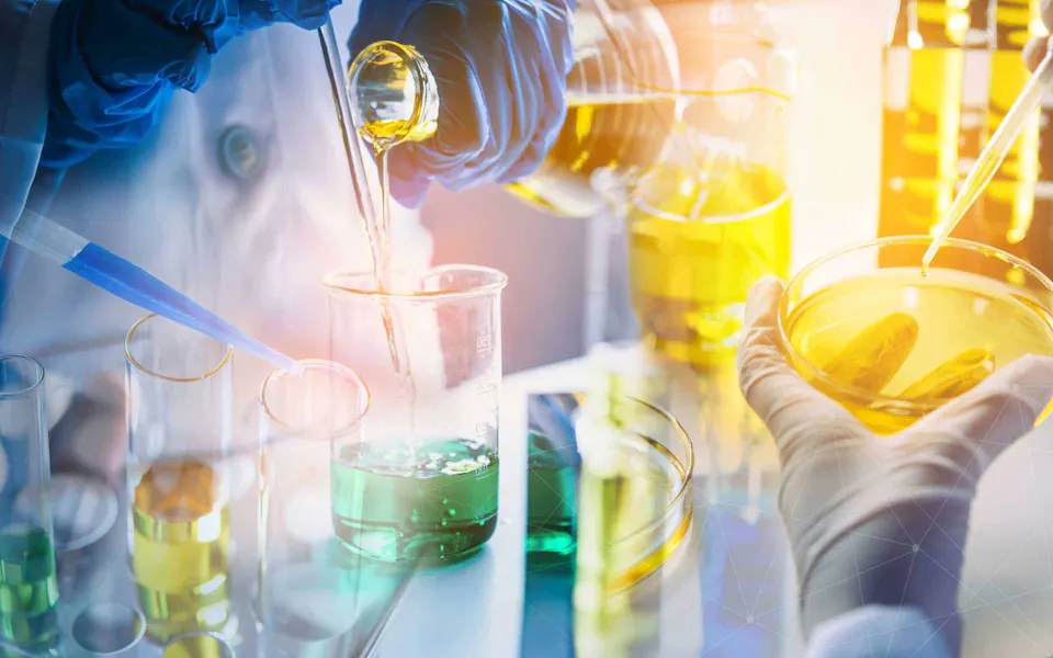 Teaser Chemical Industry Laboratory technicians in a laboratory conduct chemical experiments with colored liquids in test tubes and Petri dishes while wearing protective clothing and gloves.
