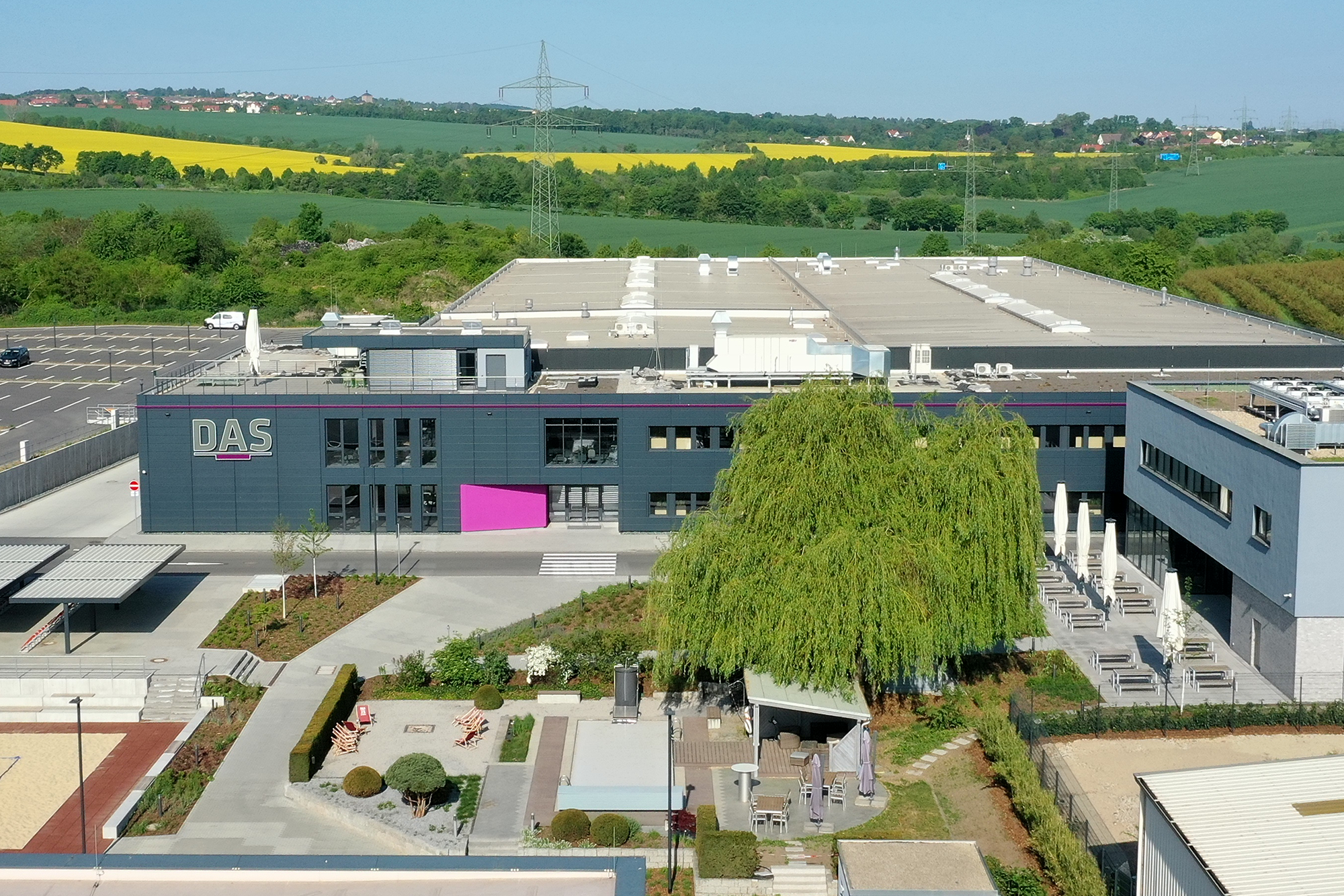 grey building with tree in front