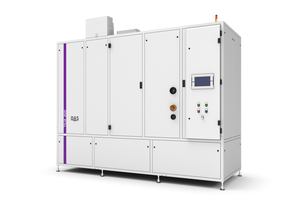 An industrial machine with the words ‘TILIA DUO’ and ‘DAS’ on the front can be seen, equipped with a digital display, various controls and a small coloured signal system on the top.