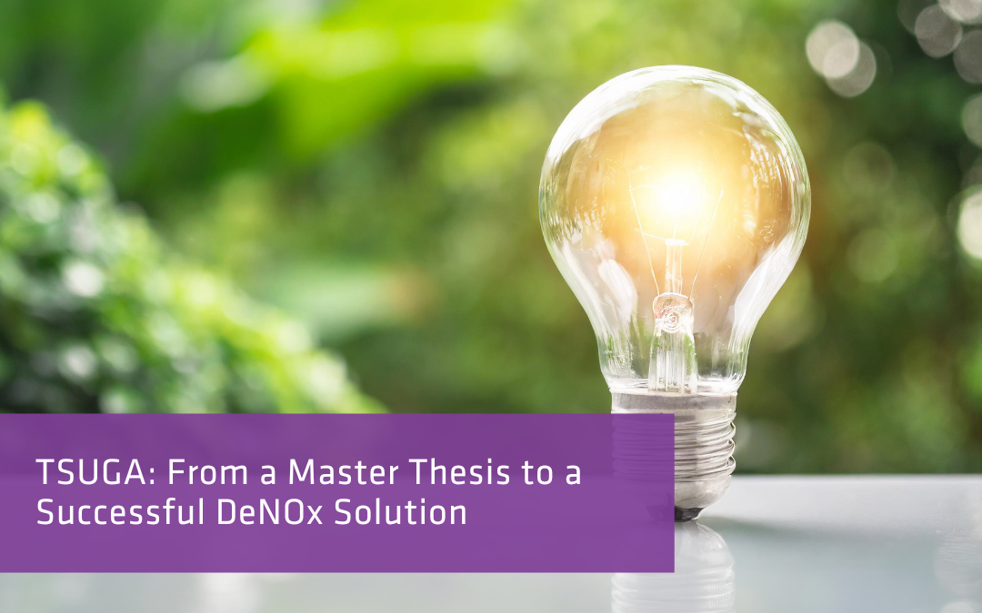 A glowing light bulb rests on a reflective surface against a blurred backdrop of lush green foliage, suggesting innovation and sustainability.