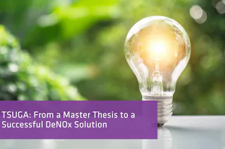 TSUGA — A Success Story A glowing light bulb rests on a reflective surface against a blurred backdrop of lush green foliage, suggesting innovation and sustainability.